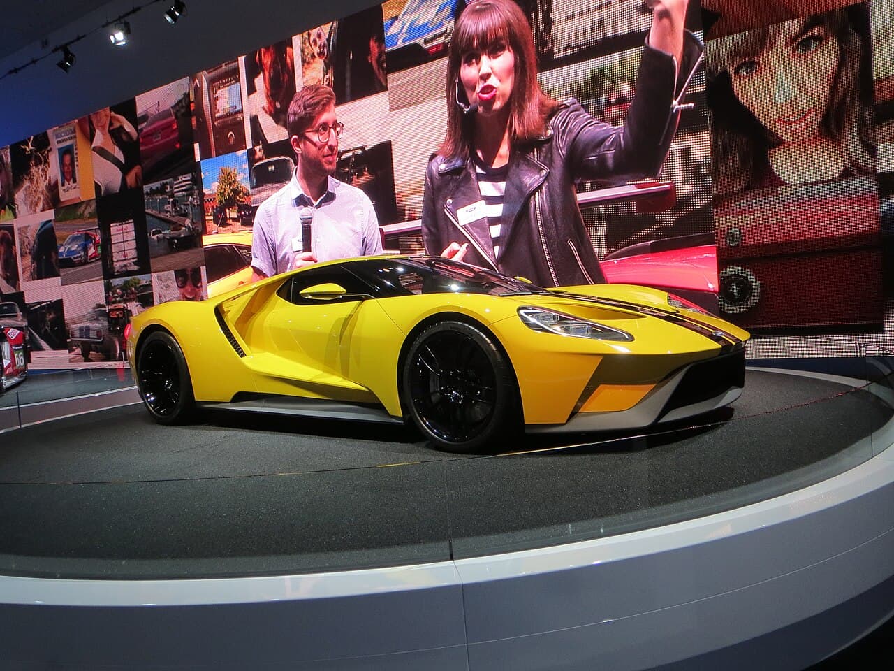 The second-generation Ford GT on its show stand, the carbon-fibre supercar built to return Ford to Le Mans. Wikimedia Commons · Tracey Adams · CC BY 2.0